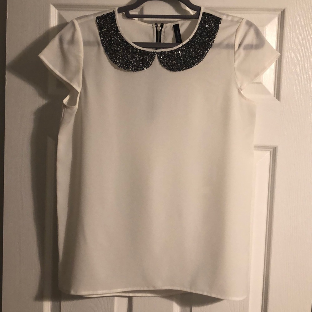 White blouse with small black sequin collar detail